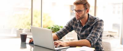 man typing on laptop