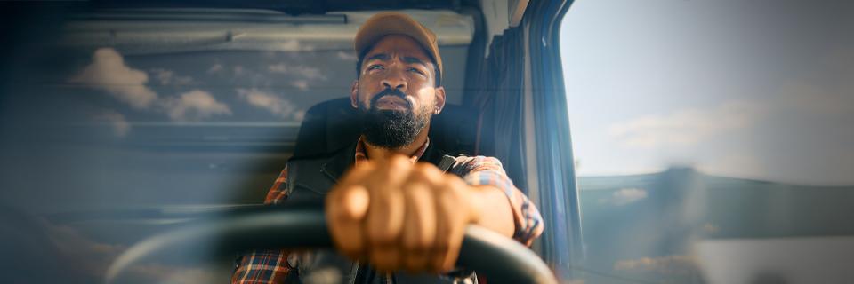 Truck driver grabbing steering wheel
