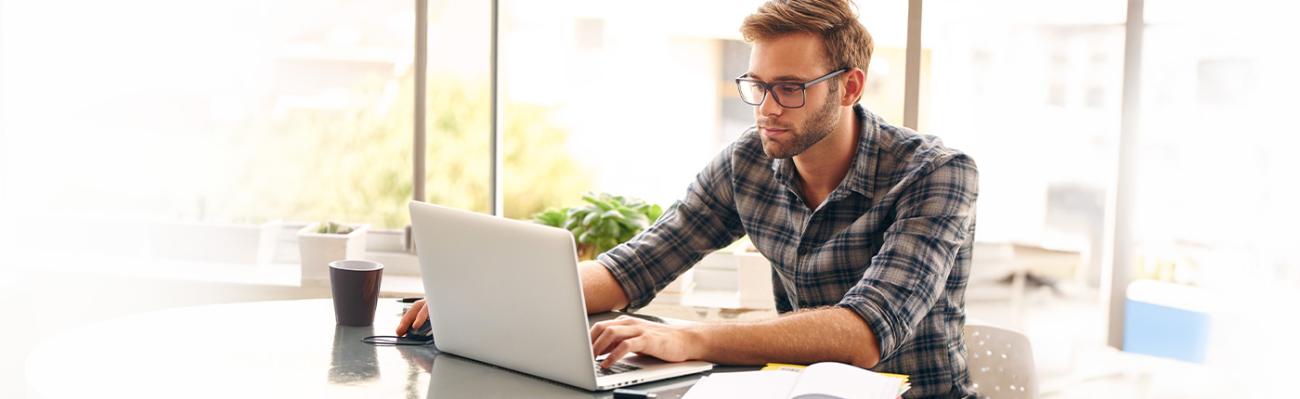 man typing on laptop